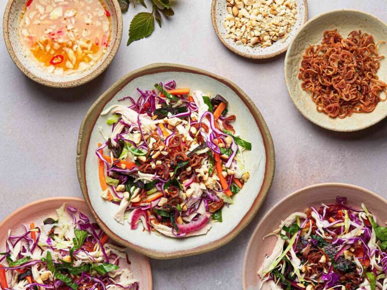A classic Vietnamese salad of tender chicken, crunchy cabbage, sweet carrot, pickled onion, fresh herbs, and crispy toppings, served with a gingery dipping sauce