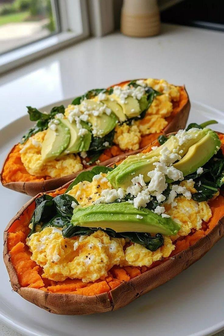 stuffed sweet potatoes with scrambled eggs spinach avocado and feta